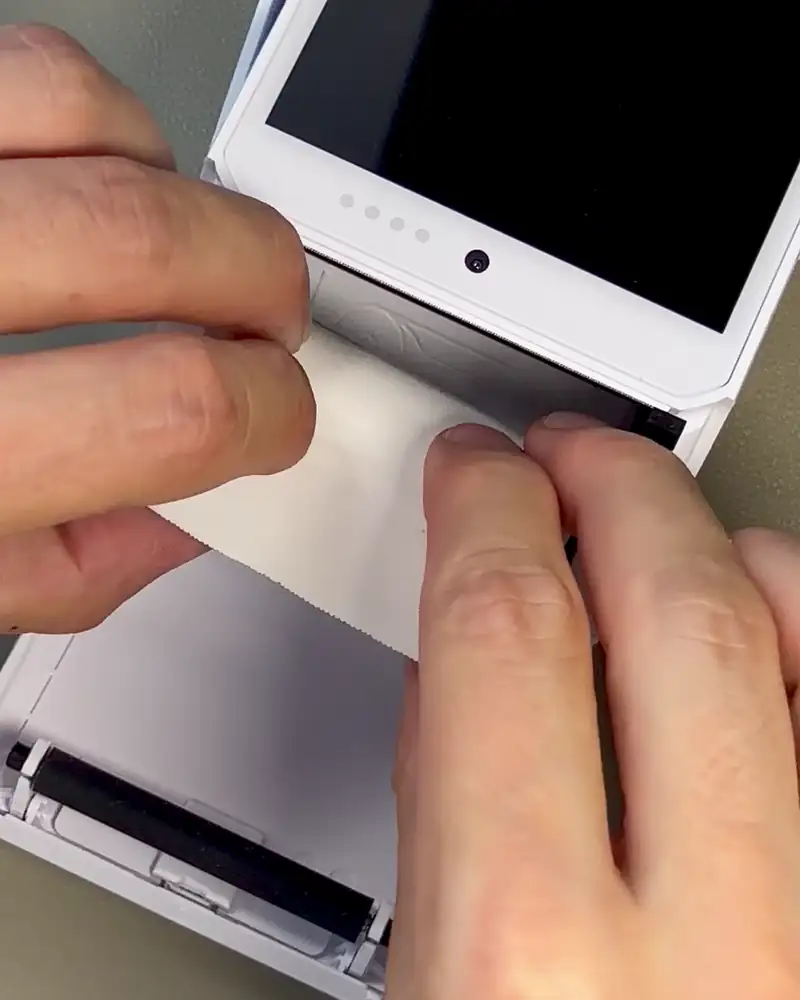 Adding a paper roll to the DX8000 and closing the printer lid firmly with paper visible outside